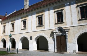 Historisches Gebäude mit Arkaden und Holztür in Pulkau.